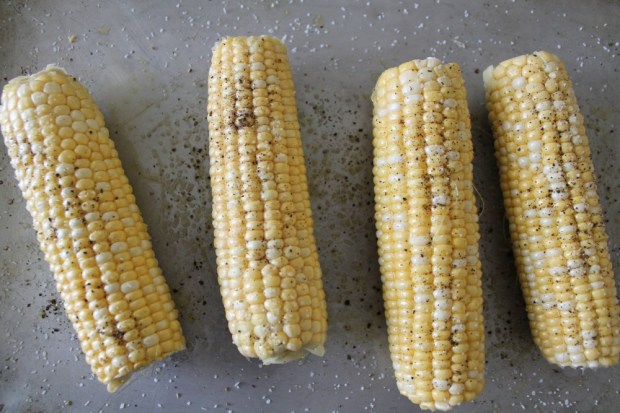 Rub each ear of corn with olive oil. Sprinkle with salt and pepper. Roast in a preheated 425 degree oven for about 45 minutes. Rotate ears for even roasting.